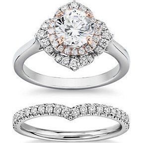 A bridal set that has a halo engagement ring in a fancy floral shape and a band that is designed to match.